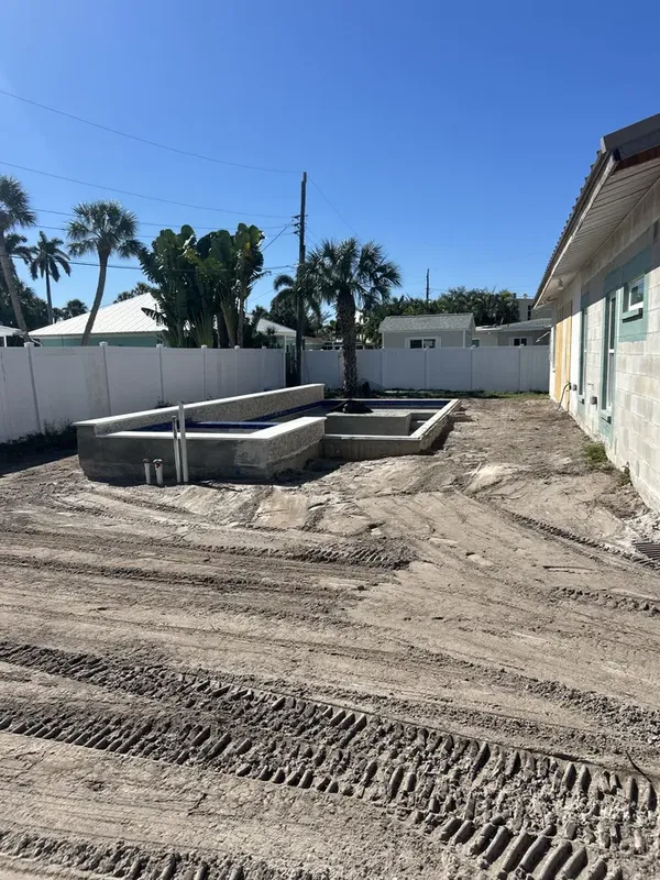 Completed pool shell with graded backfill ready for deck work in Sarasota FL