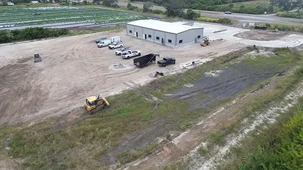 Aerial view of commercial site grading with multiple pieces of heavy equipment in Bradenton FL